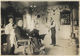 Alexander “Alex” Arhelger’s barbershop, located in the 100 block of East Main Street, 1910-1930.