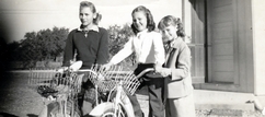Shirley Kunz, Janet Ahrens, and Patsy Lott stand in front of the White Oak School.
