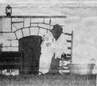 Pioneer Mother Jennifer Jenschke tries to calm her children with a story about Easter eggs and the fires which are glowing all around.  The children are portrayed by Hannah Reininger and Jacob Jenschke.
